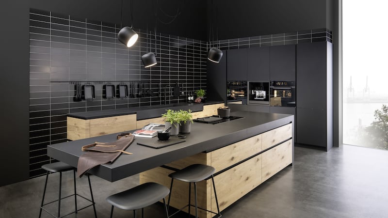 Modern Mix Uno handle-less kitchen combines an oiled cracked oak veneer with sleek matt black units in a Monolack, a new lacquered laminate finish. Features include a pull-out coffee machine module and a Passe-Partout internal storage system (from &pound;12,000), Rational&nbsp;