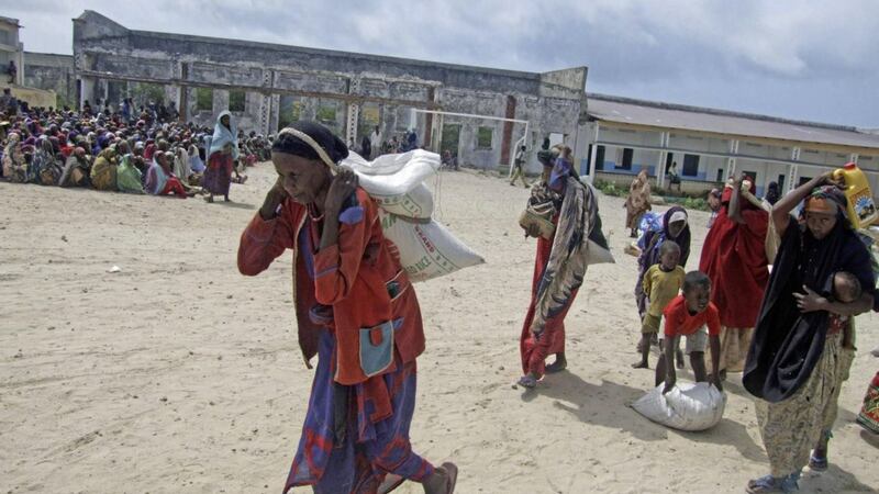Somali women walk after receiving rations at a displaced camp in Mogadishu Somalia. Picture by Mohamed Sheikh Nor, Associated Press 