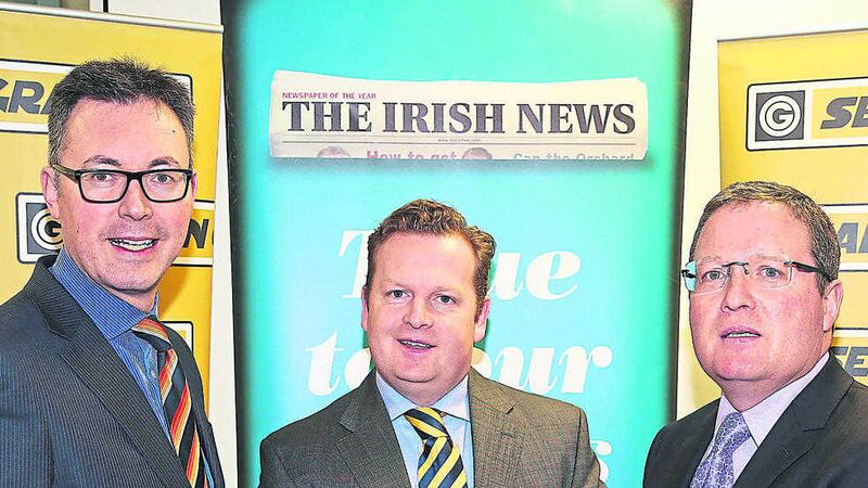 Brian Graham (right) and Ronan Grahamm (centre) with marketing manager of The Irish News John Brolly Picture by Mal McCann