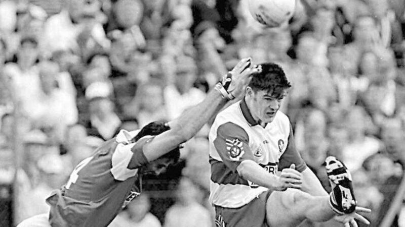 Enda Gormley in his heyday with Derry, shooting over despite an attempted block by Armagh's Martin Toye Picture by Ann McManus