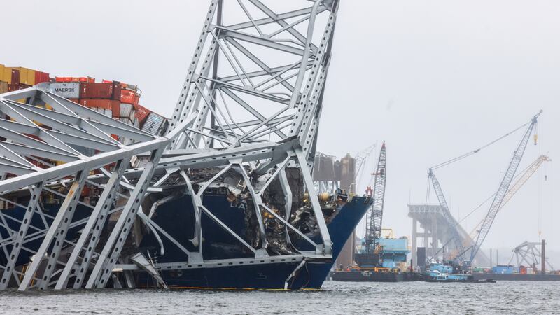 Cranes continue salvage work as wreckage of the Francis Scott Key Bridge rests on the container ship Dali (Julia Nikhinson/AP)