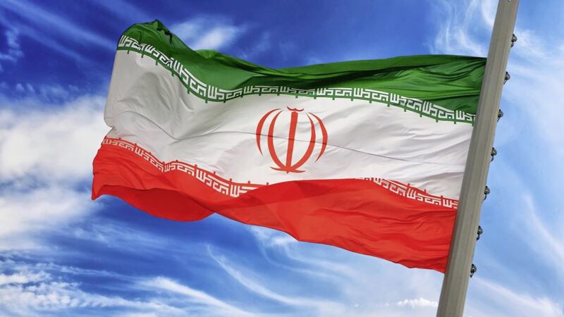 Flag of Iran against the blue sky 