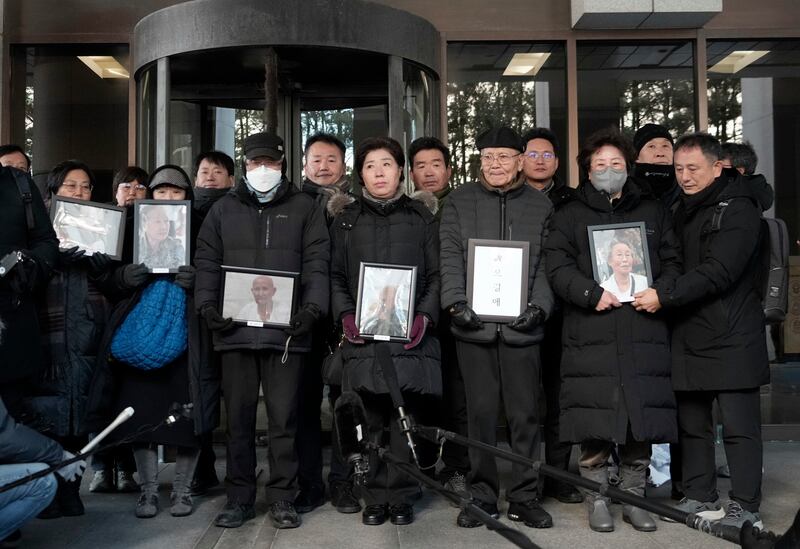 Family members of forced labour victims speak to the media at the Supreme Court in Seoul, South Korea on Thursday (Ahn Young-joon/AP)