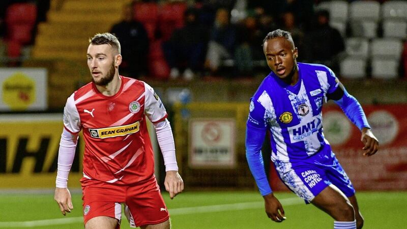 Cliftonville&#39;s Jamie McDonagh keeps the ball away from Newry&#39;s Favour Kwelele during the Bet McLean League Cup quarter-final earlier this month at Solitude. 