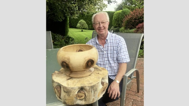 Bruce Switzer with finished bowl and raw log from the monkey puzzle tree 