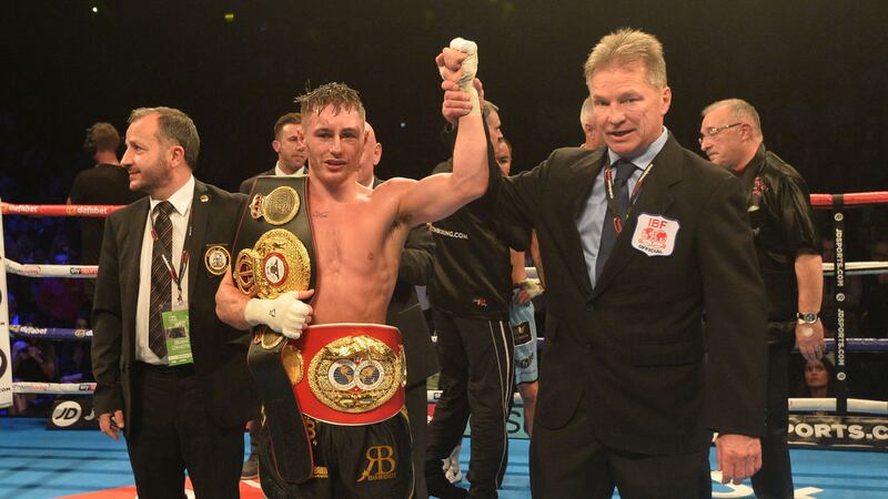 Ryan Burnett celebrates with his belts at the SSE Arena on Saturday evening