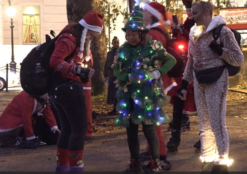 Woman wearing Christmas tree outfit at London Santa Skate
