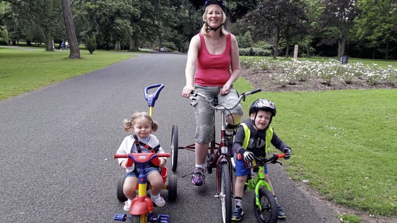 Lisa Lecky enjoying being out on her specially adapted trike bike with her two young children in Ormeau Park, Belfast 