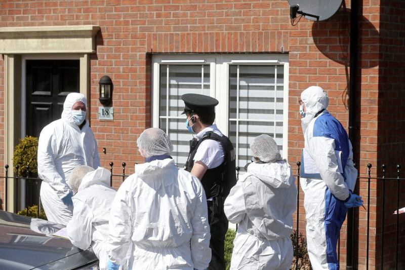 Forensic officers at the scene of the house fire in the Meadow Crescent area of Lisburn yesterday. Picture by Mal McCann 