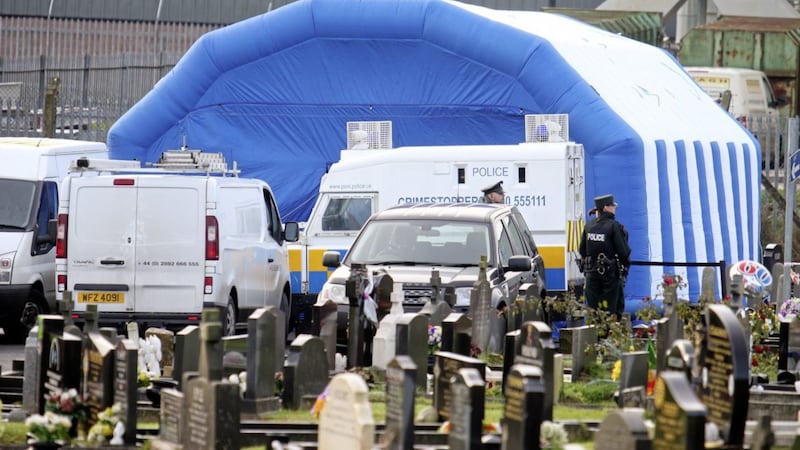 Police at the exhumation of the body of Daniel Rooney in Milltown Cemetery this week. Picture Mal McCann. 