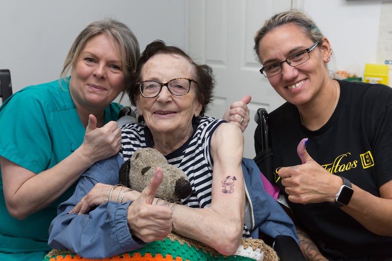 Dorothy France (middle) , 89, had a cartoon dog Snoopy tattooed on her left arm (Care UK)