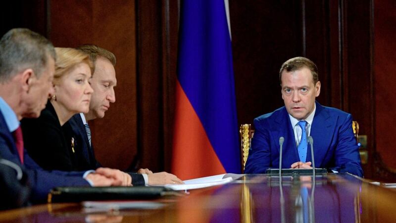 Russian prime minister Dmitry Medvedev, right, leads a cabinet meeting in the Gorky residence outside Moscow, yesterday. Mr Medvedev ordered his cabinet to draw up measures to support sanctioned companies in the energy, metals and arms sectors, Russian news agencies reported PICTURE: Alexander Astafyev/Sputnik/Government/AP 