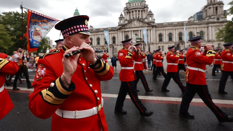 A flute band passes Belfast City Hall as they accompany Orange Order members for the Twelfth parade. Picture by Liam McBurney/PA Wire
