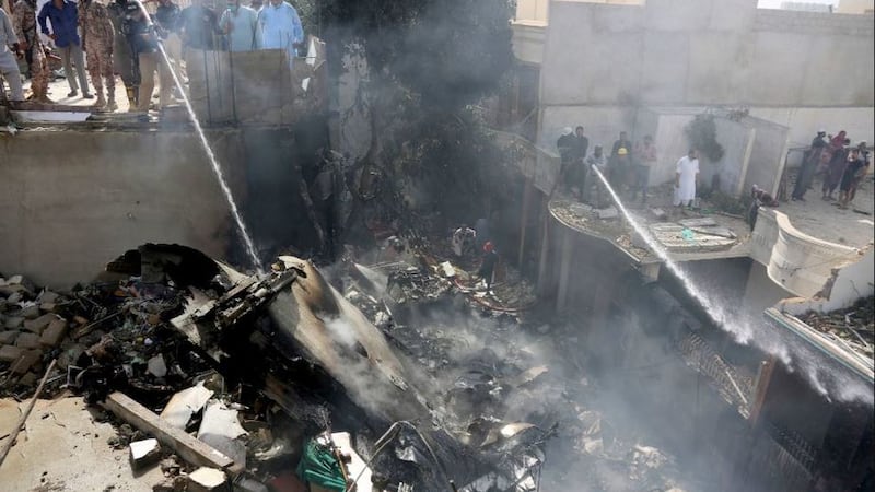 &nbsp;Firefighters try to put out a fire caused by a plane crash in Karachi, Pakistan, on May 22 2020. Picture by&nbsp;Fareed Khan, AP