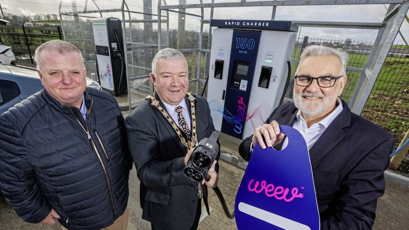 Mayor of Causeway Coast and Glens Borough Council, Cllr Ivor Wallace (centre) officially opens Weev&rsquo;s EV charging hub in Cloughmills, with Barney McGuckian (left) , owner of McGuckian Milling Company and Philip Rainey, CEO of Weev. 
