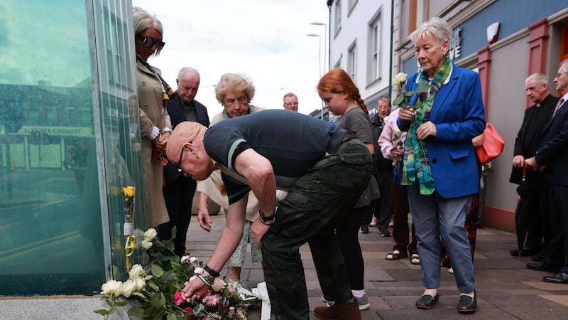 Kevin Skeldon, whose wife Philomena died in the Omagh atrocity, lays flowers at the site of the bombing to mark the 25th anniversary (Liam McBurney/PA)