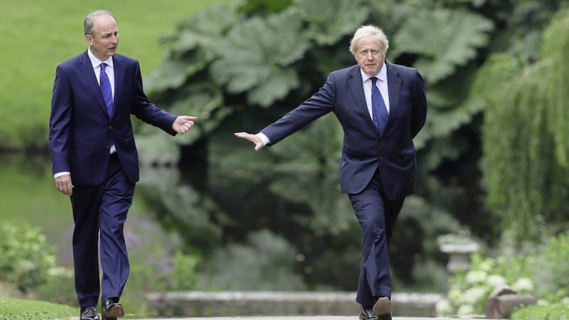 Taoiseach Mich&eacute;al Martin and Prime Minister Boris Johnson walking at Hillsborough Castle last summer. Picture by Brian Lawless/PA Wire 