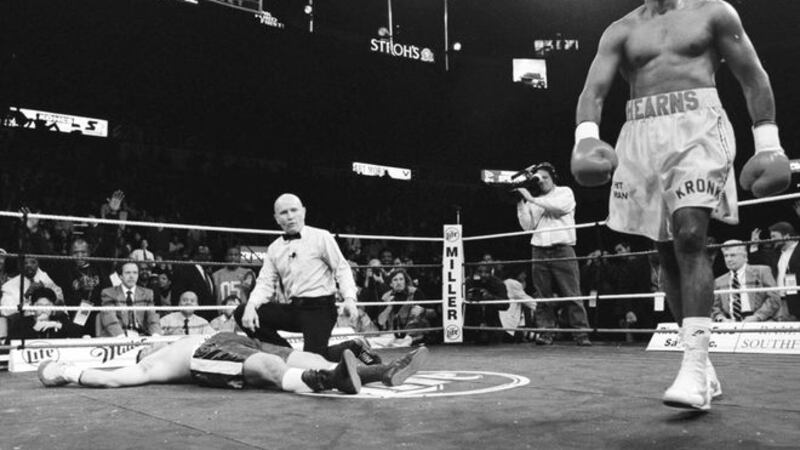 Thomas Hearns, (40) of Southfield, Michigan. paces the canvas as the referree Mills Lane looks over a Jay Snyder (37) of Spartenburg, South Carolina after Hearns knocked out Snyder in 88 seconds into the first round of their cruiserweight fight at Detroit's Joe Louis Arena on Friday Novemeber 6 l998