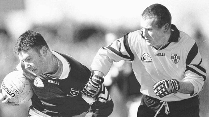 FORWARD TRACKS BACK....Ulster&rsquo;s Down forward James McCartan tries to halt the progress of Munster&rsquo;s Joe Kavanagh during the 1999 Railway Cup semi-final replay at Healy Park 