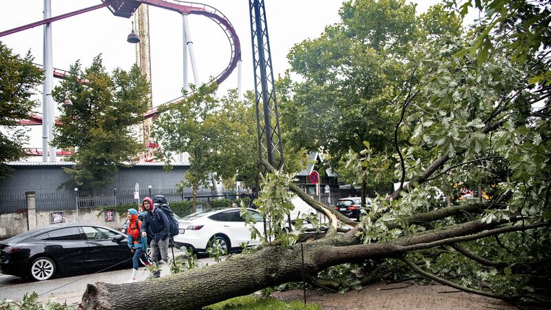 A tree lies on the ground close to the amusement park Tivoli after falling following a heavy storm, in Copenhagen (Ritzau Scanpix via AP)