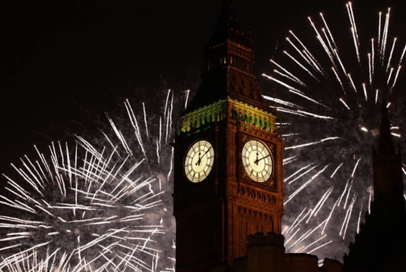 The Queen Elizabeth tower, home to Big Ben, seen on New Year's Eve with fireworks in the background, (Yui Mok/PA)