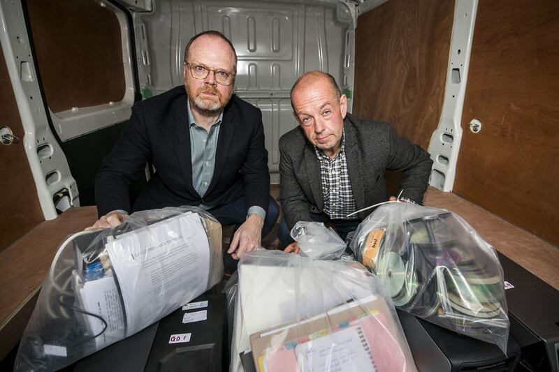 Investigative journalists Trevor Birney (left), and Barry McCaffrey outside Castlereagh Police Station in Belfast, with a haul of journalistic material unlawfully seized by police following the making of the Loughinisland documentary No Stone Unturned&nbsp;