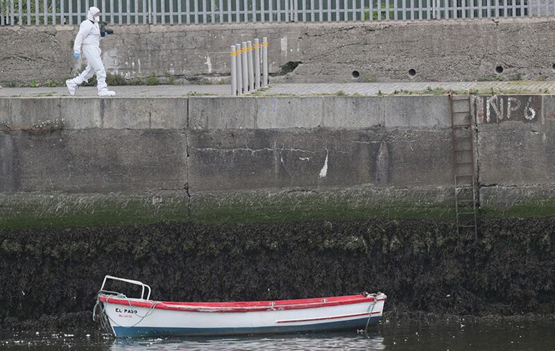 A forensics investigator on the harbour wall in Bray, Co Wicklow, near to the Bray Boxing Club where three people were shot this morning&nbsp;