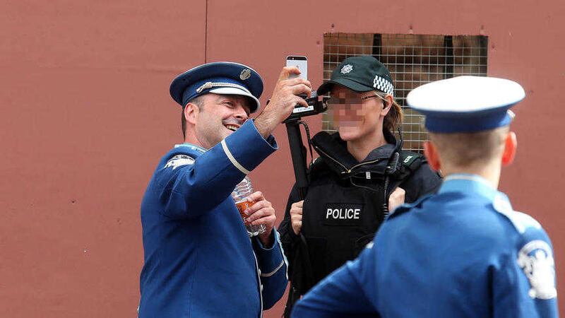 A Scottish band member takes a &#39;Twelfie&#39; with a police officer in Donegall Street, Belfast during Tuesday&#39;s Twelfth of July celebrations. Picture Mal McCann 