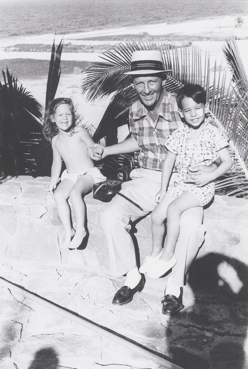 Bing Crosby enjoying time on the beach with his young children Mary and Harry