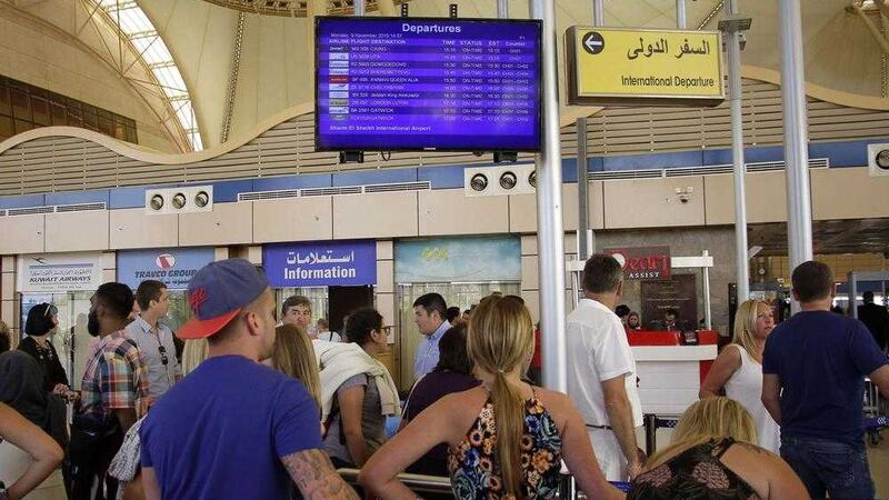 Passengers check the departure information board at Sharm el-Sheikh Airport in south Sinai, Egypt. Picture by Ahmed Abd El-Latif/AP