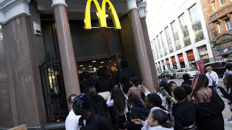 Youths run into a McDonalds store on Oxford Street in central London (Aaron Chown/PA)
