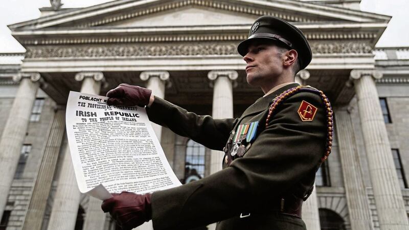 Captain Michael Barry of the Irish Defence Forces holds a copy of the Proclamation during a ceremony to mark the 101st anniversary of the 1916 Easter Rising outside the GPO PICTURE: Brian Lawless/PA 