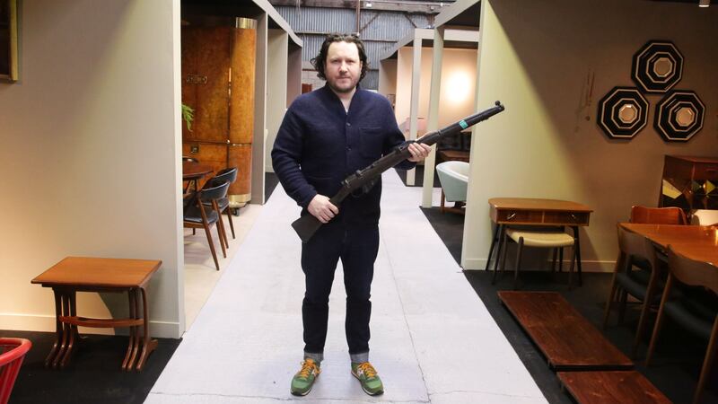 Killian McNulty of Historic Interiors with a prop rifle used in the 1996 film Michael Collins (Niall Mullen/PA)