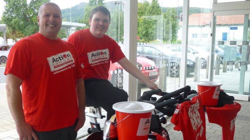 David Finlay and Adam McCrea cycle in situ for Action Cancer at M&amp;S Newtownabbey 