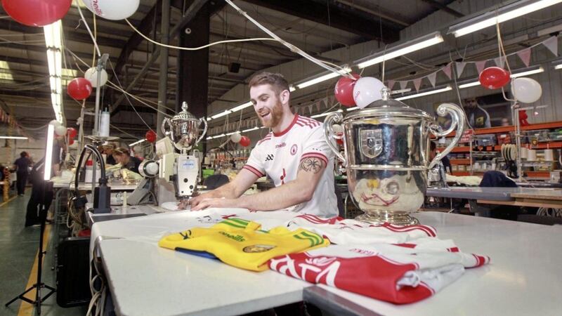 Tyrone&#39;s Ronan McNamee has a go on a sewing machine in the O&#39;Neills factory in Strabane. Picture Margaret Mclaughlin  