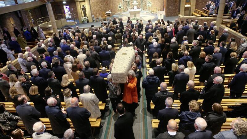 The remains of Irish News Chairman Jim Fitzpatrick are carried by his family from St Brigid&#39;s Church, Belfast. Picture by Mal McCann. 