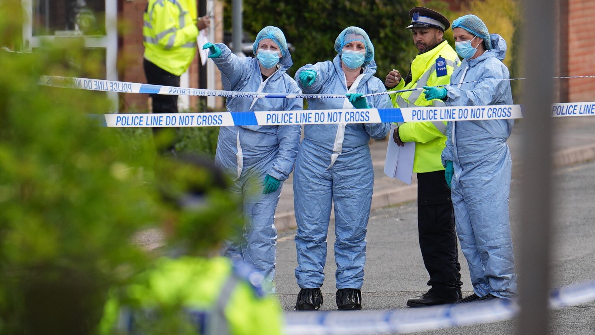 Forensic investigators in Laing Close in Hainault, north east London, after a 14-year-old boy died after being stabbed and a sword-wielding man arrested