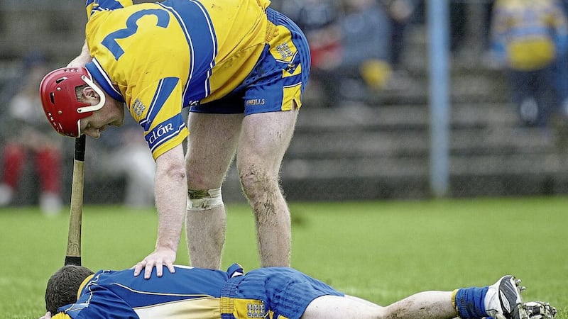 Brian Lohan checks on the welfare of Clare team-mate Davy Fitzgerald during a League game with Cork in 2005. The goodwill between the Banner legends has long since disappeared for a host of reasons which gives this weekend&rsquo;s clash between Lohan&rsquo;s Banner side and Fitzgerald&rsquo;s Waterford some added spice Picture by INPHO/Lorraine O&#39;Sullivan 