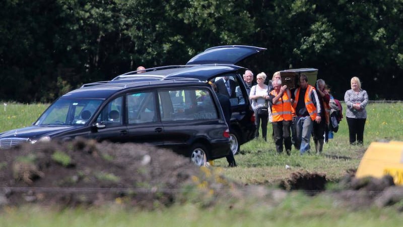 Families of two of the IRA Disappeared look on as two sets of human remains are removed from a reclaimed bog in Coghalstown, Co Meath.  Picture by Niall Carson, Press Association              