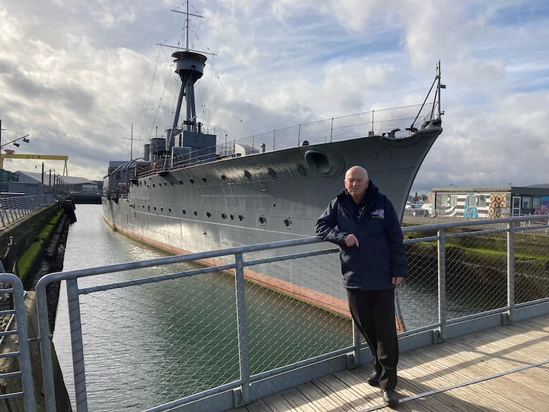 John Taylor pictured in front of HMS Caroline 