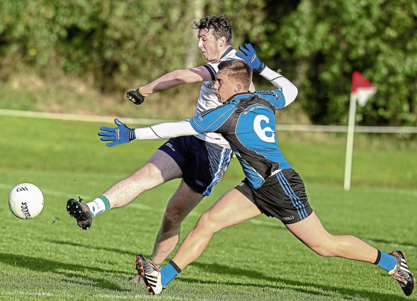 Ulster University's Thomas Clarke strikes for goal as Maynooth's Tom Hanifan attempts a block <br />Picture by Hugh Russell
