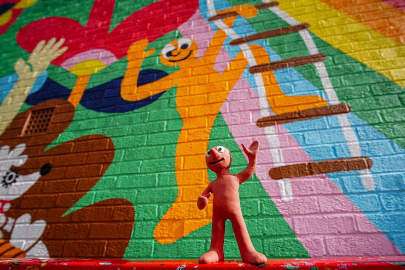Morph in front of the mural