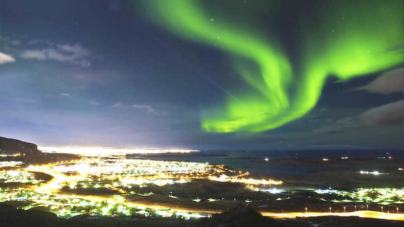 The aurora borealis over Iceland&#39;s capital city, Reykjavik 
