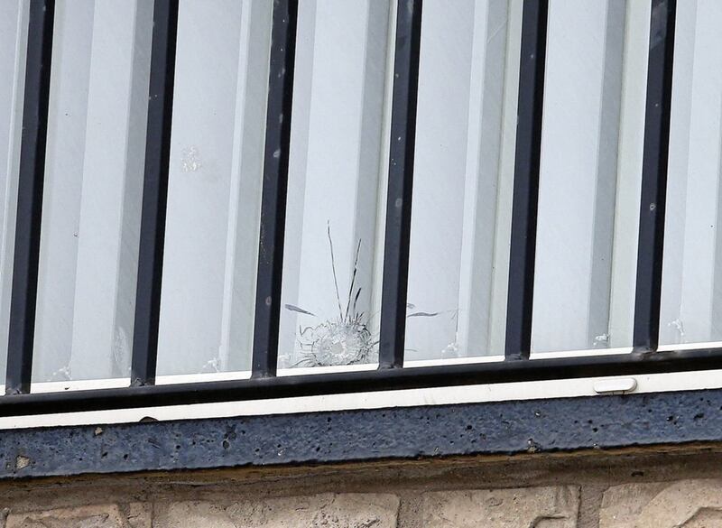 A bullethole in a window at the Sinn F&eacute;in office in Turf Lodge near the scene of the paramilitary-style attack. Picture by Mal McCann