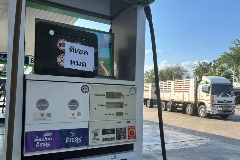 A sign announcing ‘diesel fuel has run out’ is displayed at a petrol station in Prajuab Kirikhan, Thailand (Grant Peck/AP)