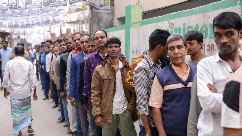Voters line up outside a polling station in Dhaka, Bangladesh (Mahmud Hossain Opu/AP)