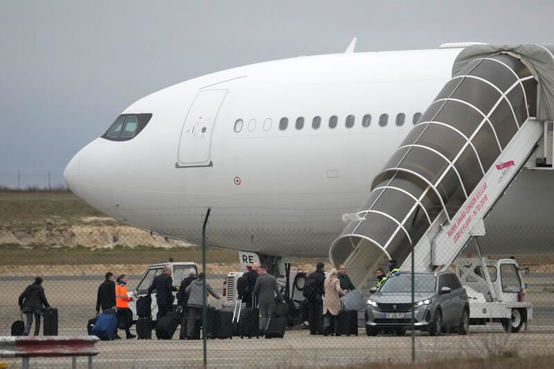 Crew members board the plane grounded by police at the Vatry airport (Christophe Ena/AP)