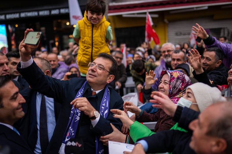 Istanbul Mayor Ekrem Imamoglu takes photographs with supporters (Francisco Seco/AP)