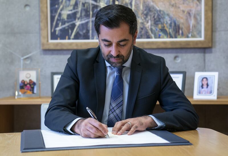 Outgoing First Minister Humza Yousaf signs his official resignation letter at the Scottish Parliament in Edinburgh.