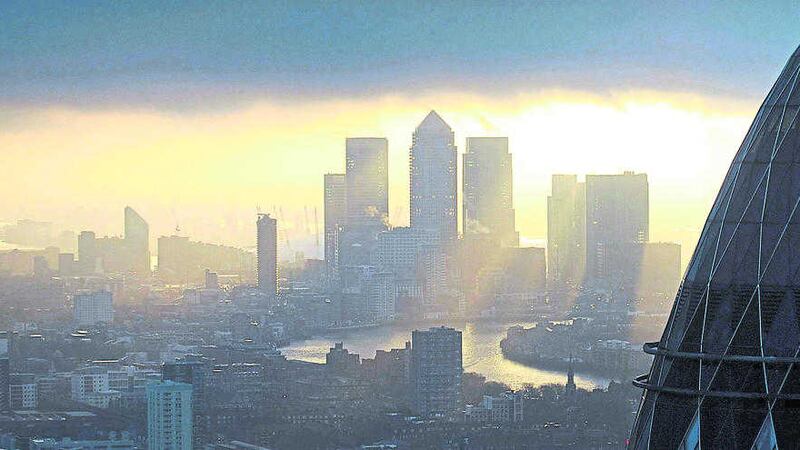 stocks rise: &lsquo;The Gherkin&rsquo; and Canary Wharf at sunrise in London. The London market surged yesterday led by reports that commodity giant Glencore is in talks to sell its agriculture business 